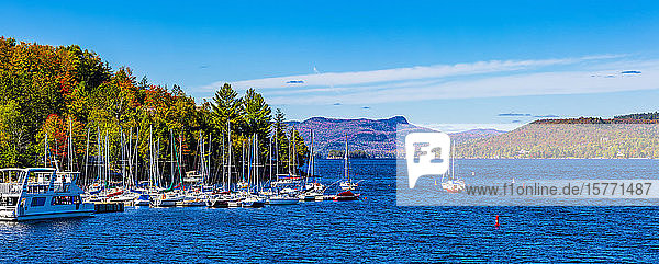 Boats mooring in a harbour in the city of Mont-Tremblant along the shoreline of a lake Laurentian Mountains; Mount-Tremblant Quebec Canada