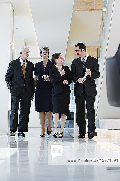 View of businesspeople walking in a corridor.