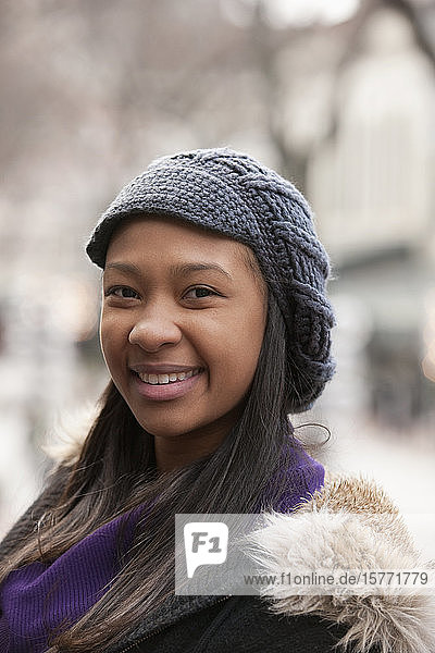 Portrait of a young woman with a city scene behind her; Boston  Massachusetts  United States of America