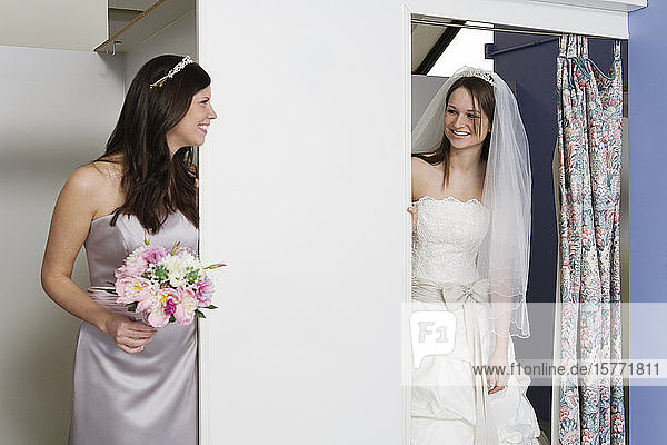 Blick auf eine fröhliche Braut und eine Brautjungfer.