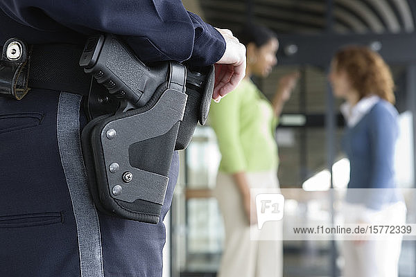 Close up of a female police womn's gun in holster.