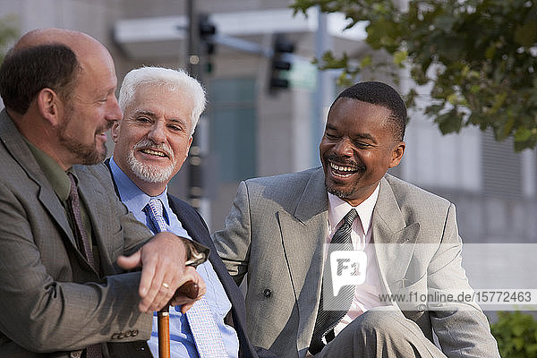 Businessmen talking and sharing insights  with one businessman holding a cane
