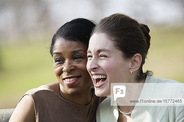 Close up of two women laughing.