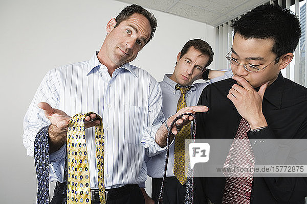 View of businessmen looking at neckties.