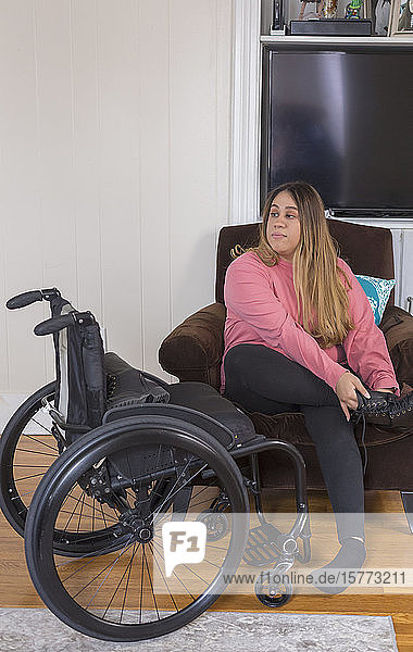 Woman with Spinal Cord Injury putting on shoes