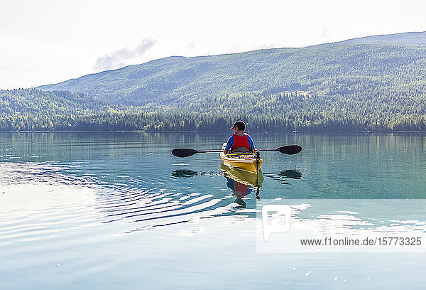 A teenage boy kayaking on White Lake  White Lake Provincial Park; British Columbia  Canada
