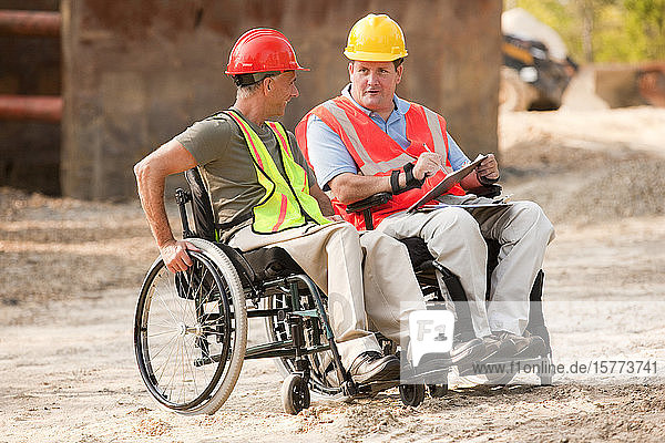 Construction job site with men in wheelchairs working together