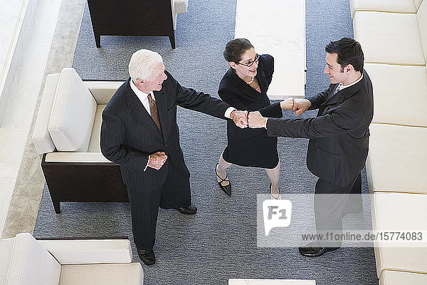 Elevated view of businesspeople smiling in an office.