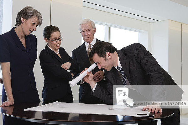 Blick auf Geschäftsleute mit einer Tabelle auf dem Schreibtisch in einem Büro.