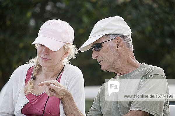 Close-up of a senior man talking to a senior woman