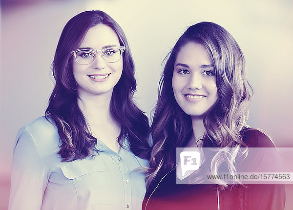 Two young woman who are friends  posing for a portrait which has been digitally modified for a vintage effect: Studio