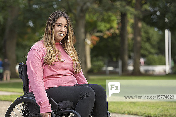 Woman with Spinal Cord Injury sitting in wheelchair in a park
