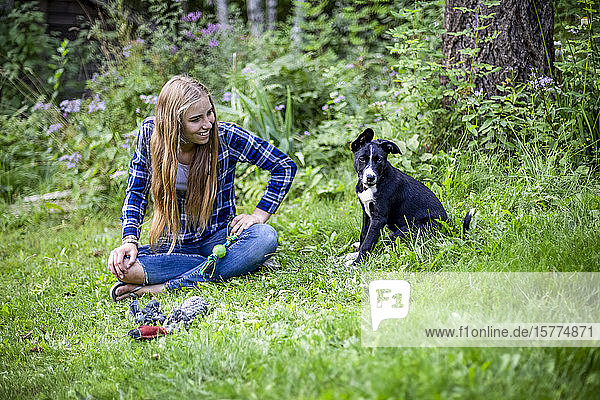 Girl with her dog in a park; Salmon Arm  British Columbia  Canada