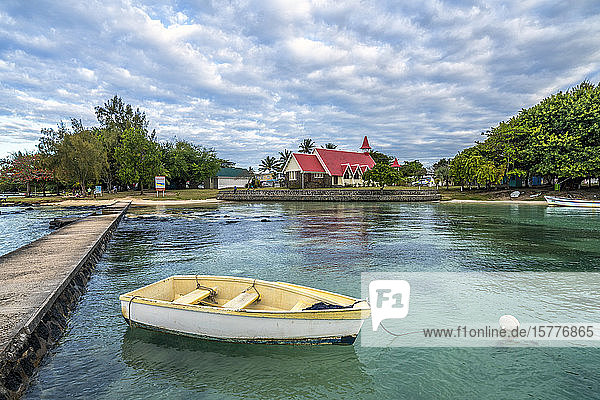 Boat moored in the sea surrounding the Notre Dame Auxiliatrice Church Cap Malheureux Mauritius Indian Ocean Africa