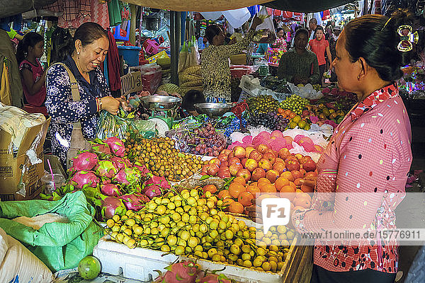 Woman shopping at a fruit stall in the central market at this old formerly French colonial river port city Kampot Cambodia Indochina Southeast Asia Asia