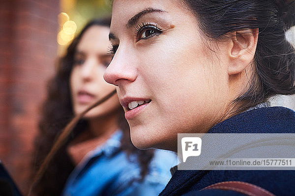Mid adult woman looking away while spending weekend with friend in city