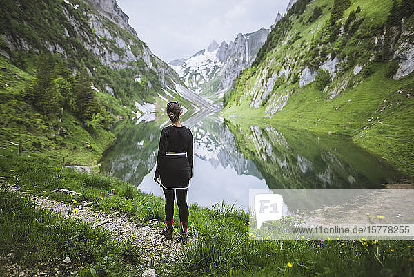 Woman by mountains and lake in Appenzell Switzerland