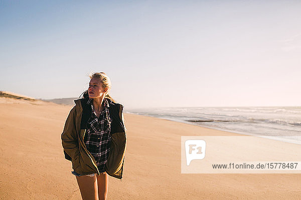 Woman wearing jacket at beach