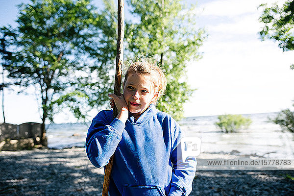 Girl exploring shore with stick  Kingston  Canada