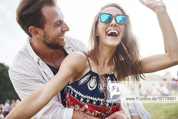 Couple laughing and enjoying music festival
