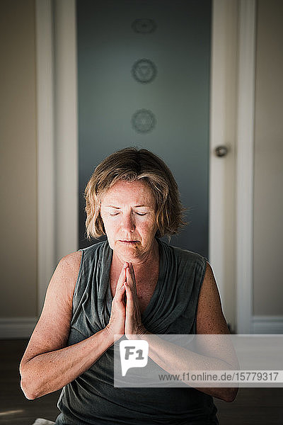 Woman with palms closed in meditation posture