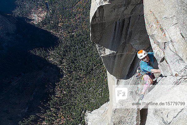 High angle view of mountaineer climbing up sheer wall of The Nose  El Capitan  Yosemite National Park.