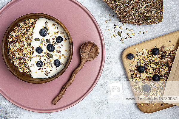 Bowl of muesli and blueberries on yogurt multi-seed bread