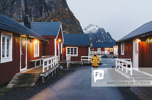 Tourist exploring the fishing village Hamnoy  Lofoten  Norway
