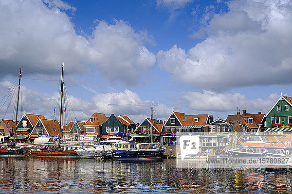 Netherlands  North Holland  Volendam  Clouds over boats moored in town harbor