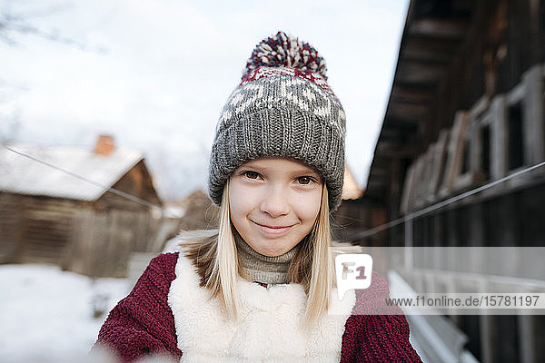 Portrait of smiling girl wearing woolly hat in winter