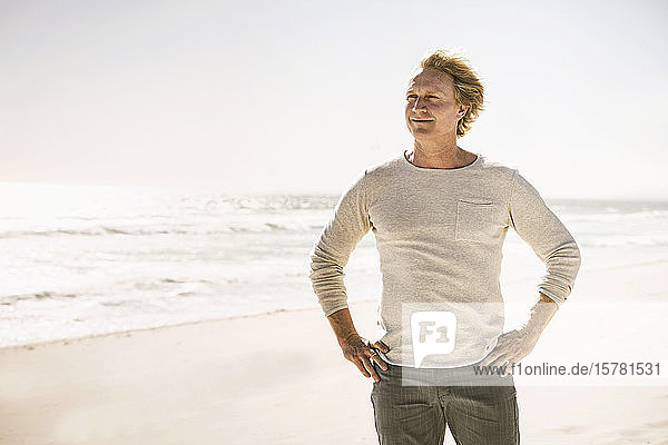 Portrait of smiling man standing on the beach