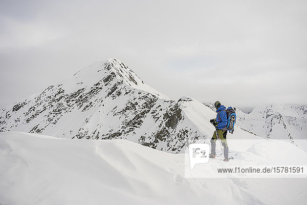Man on an excursion on the crest of a snowy mountain  Lombardy  Valtellina  Italy