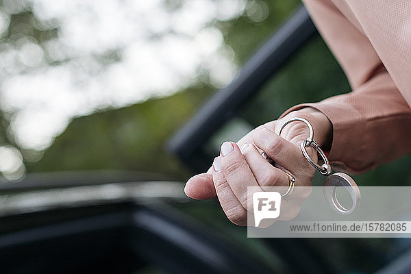 Woman's hand holding car key  close-up