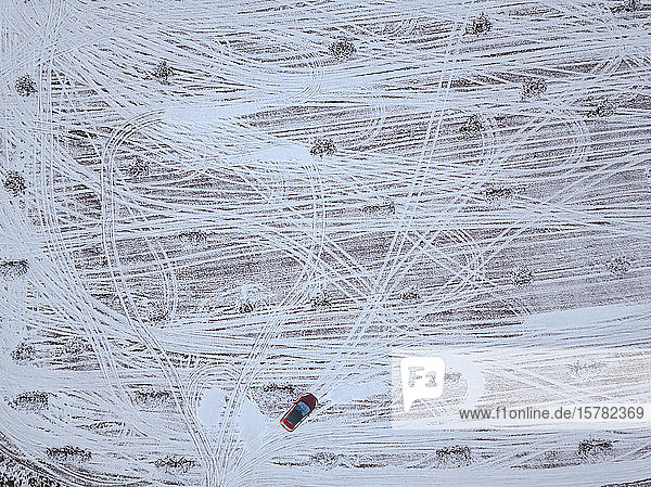 Russia Moscow Oblast Aerial view of car driving in snow-covered field