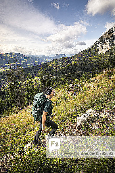 Woman with dog hiking at Wilder Kaiser  Kaiser mountains  Tyrol  Austria