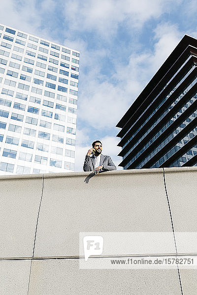 Casual young businessman on the phone in the city