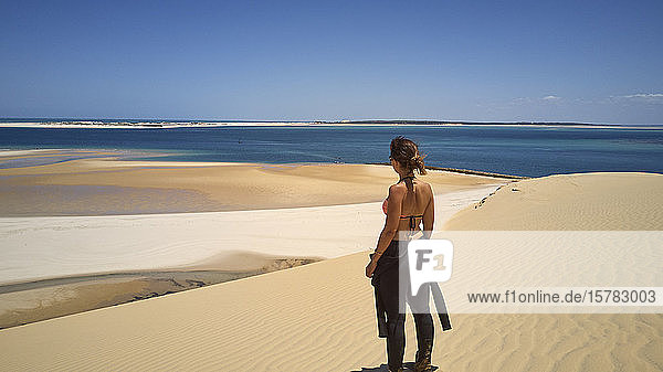 Mozambique  Bazaruto archipelago  Woman in a diving suit at Bazaruto dunes and the Indic ocean