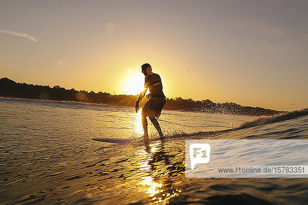 Surfer at sunset  Bali  Indonesia