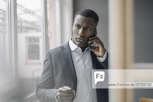 Portrait of young businessman on the phone