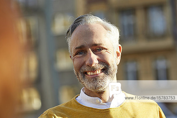Portrait of smiling mature man in the city
