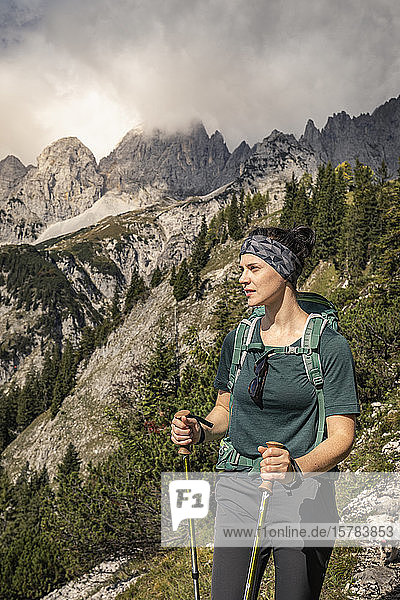 Woman on a hiking trip at Wilder Kaiser enjoying the view  Kaiser mountains  Tyrol  Austria