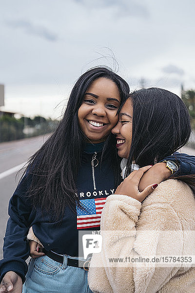 Porträt von zwei glücklichen jungen Frauen auf einer Straße
