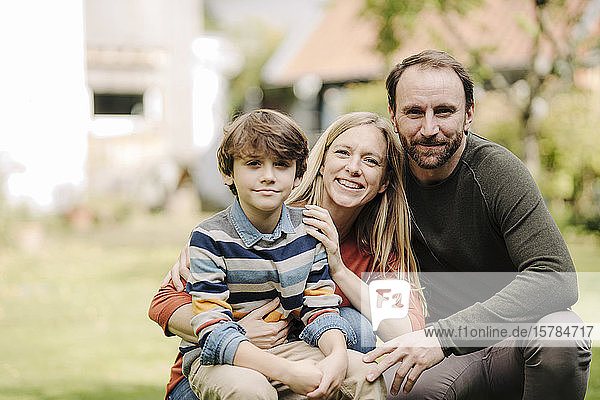 Happy family in garden  portrait