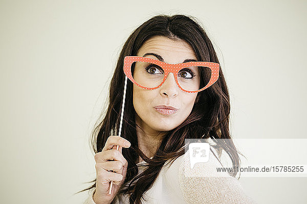 Portrait of young woman with comedy glasses