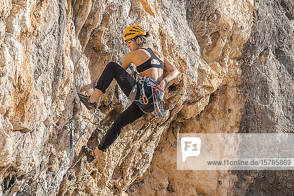 Woman climbing at rock face