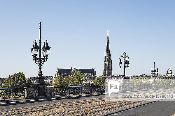 France Gironde Bordeaux Clear sky over Pont de Pierre with Basilica of Saint Michael in background