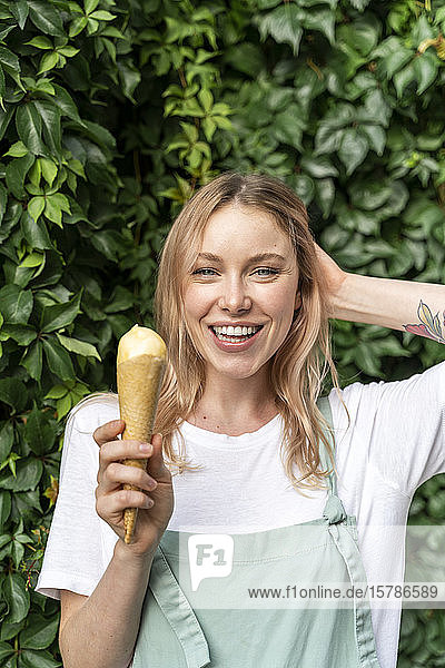 Portrait of happy young woman with ice cream cone