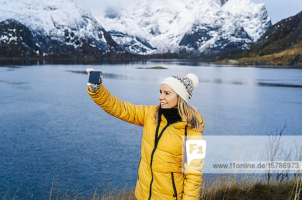 Tourist taking a selfie at Hamnoy  Lofoten  Norway