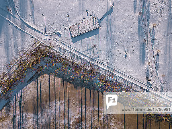 Russia Leningrad Oblast Tikhvin Aerial view of snow-covered road stretching along frozen pond