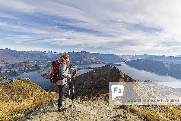 Woman standing on viewpoint at Roys Peak  looking to Mount Aspiring  Lake Wanaka  South Island  New Zealand